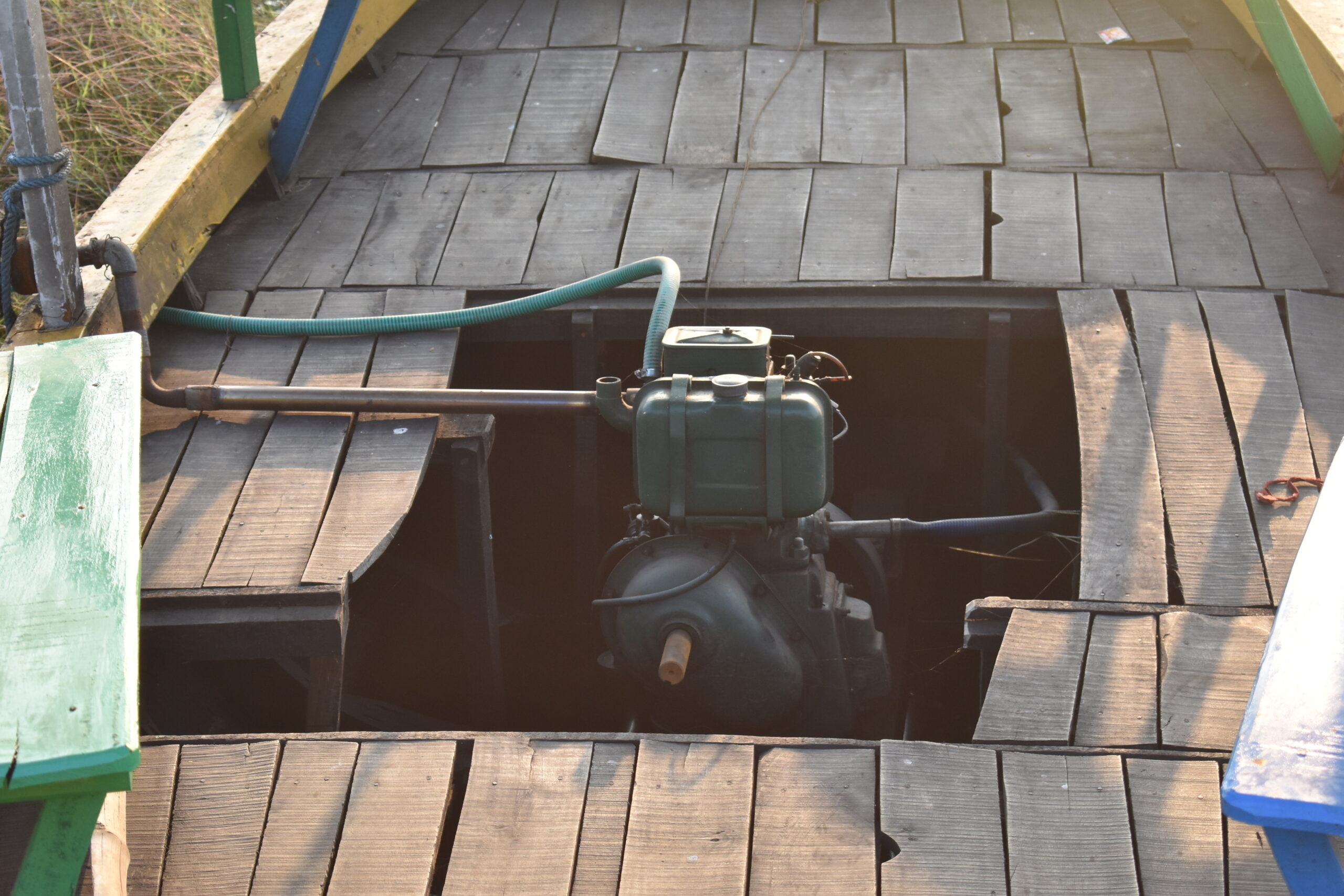 Engine visible through boat's wooden floor