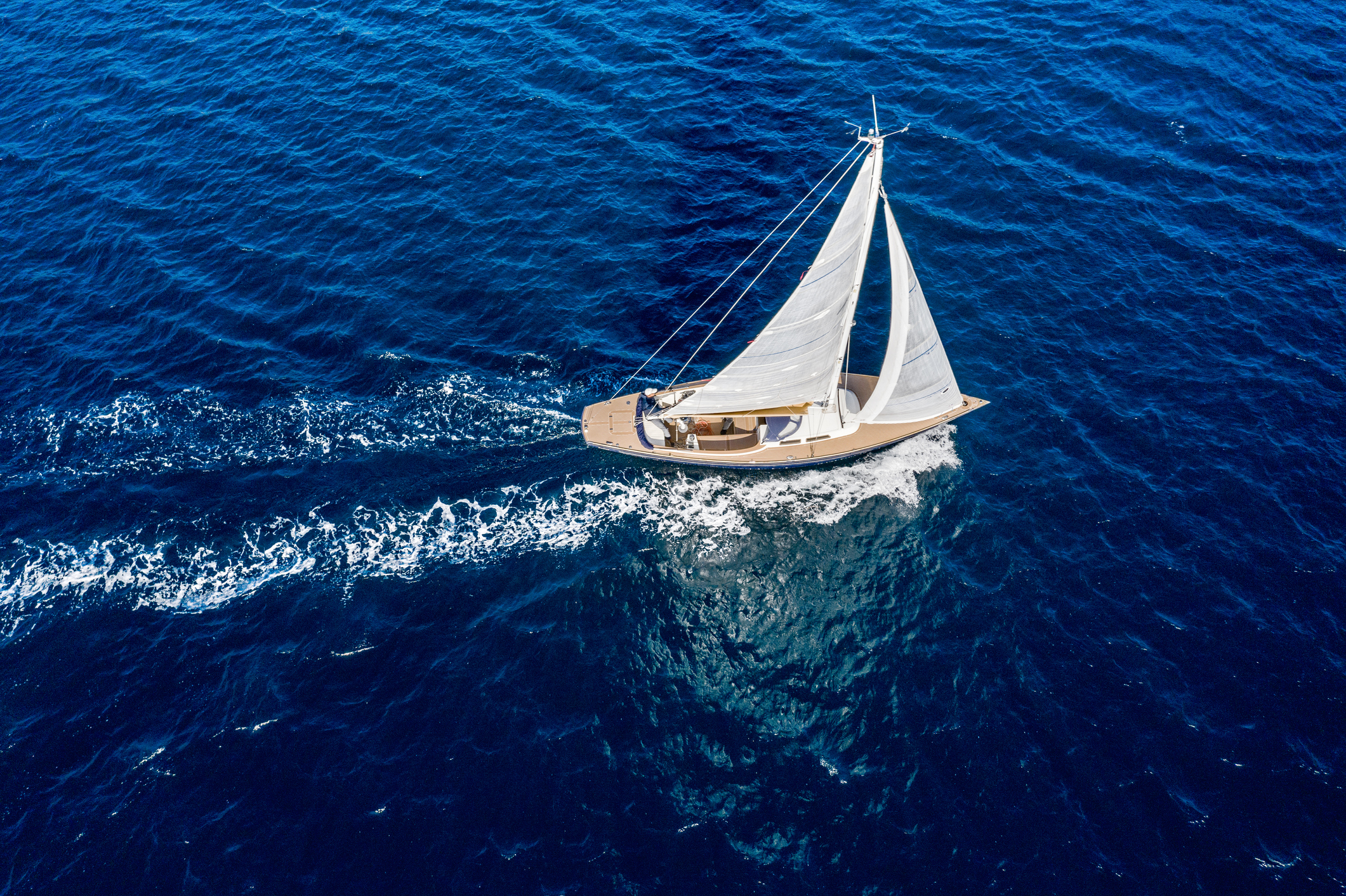 Sailboat gliding on open sea