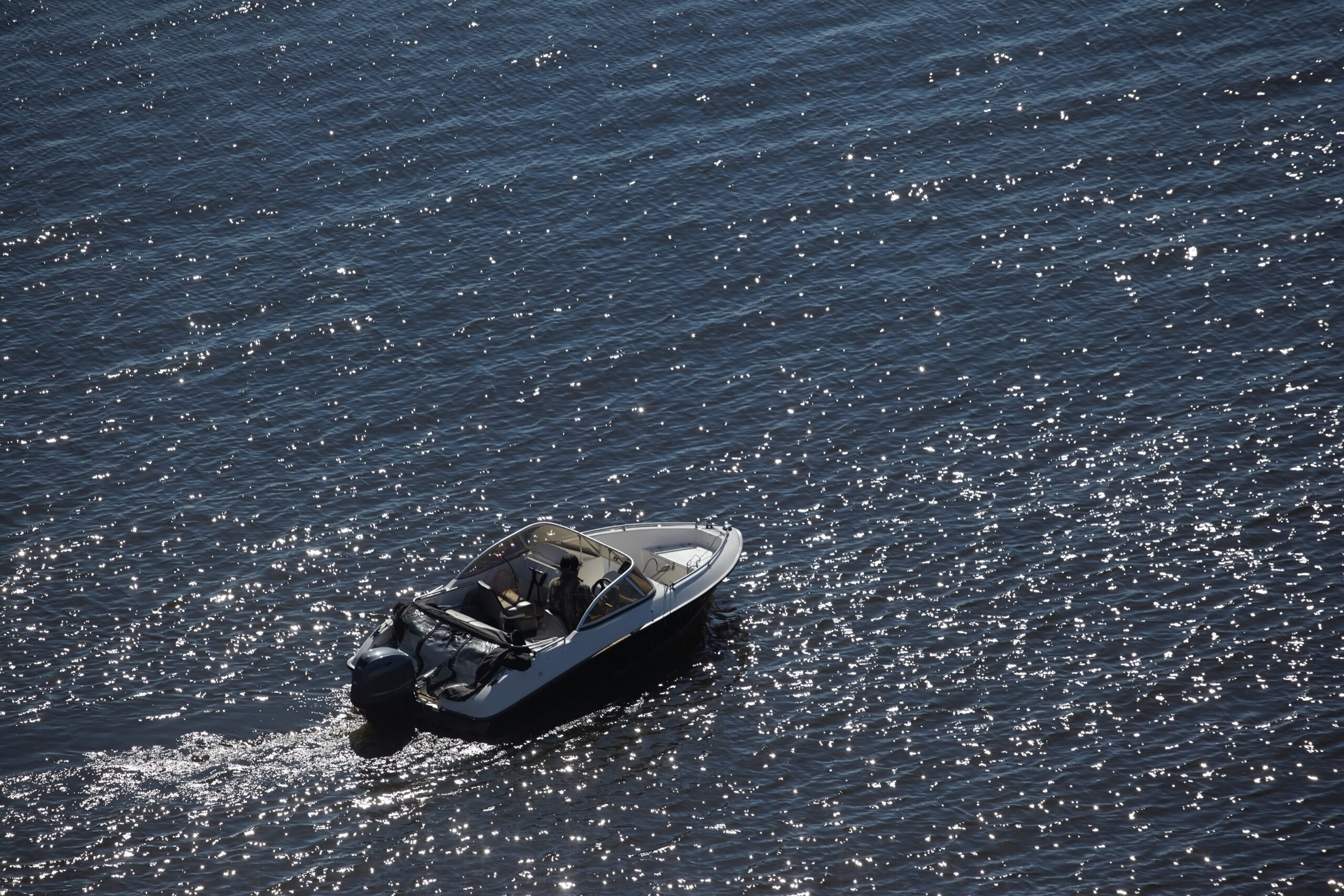 Speedboat cruising through sparkling waves