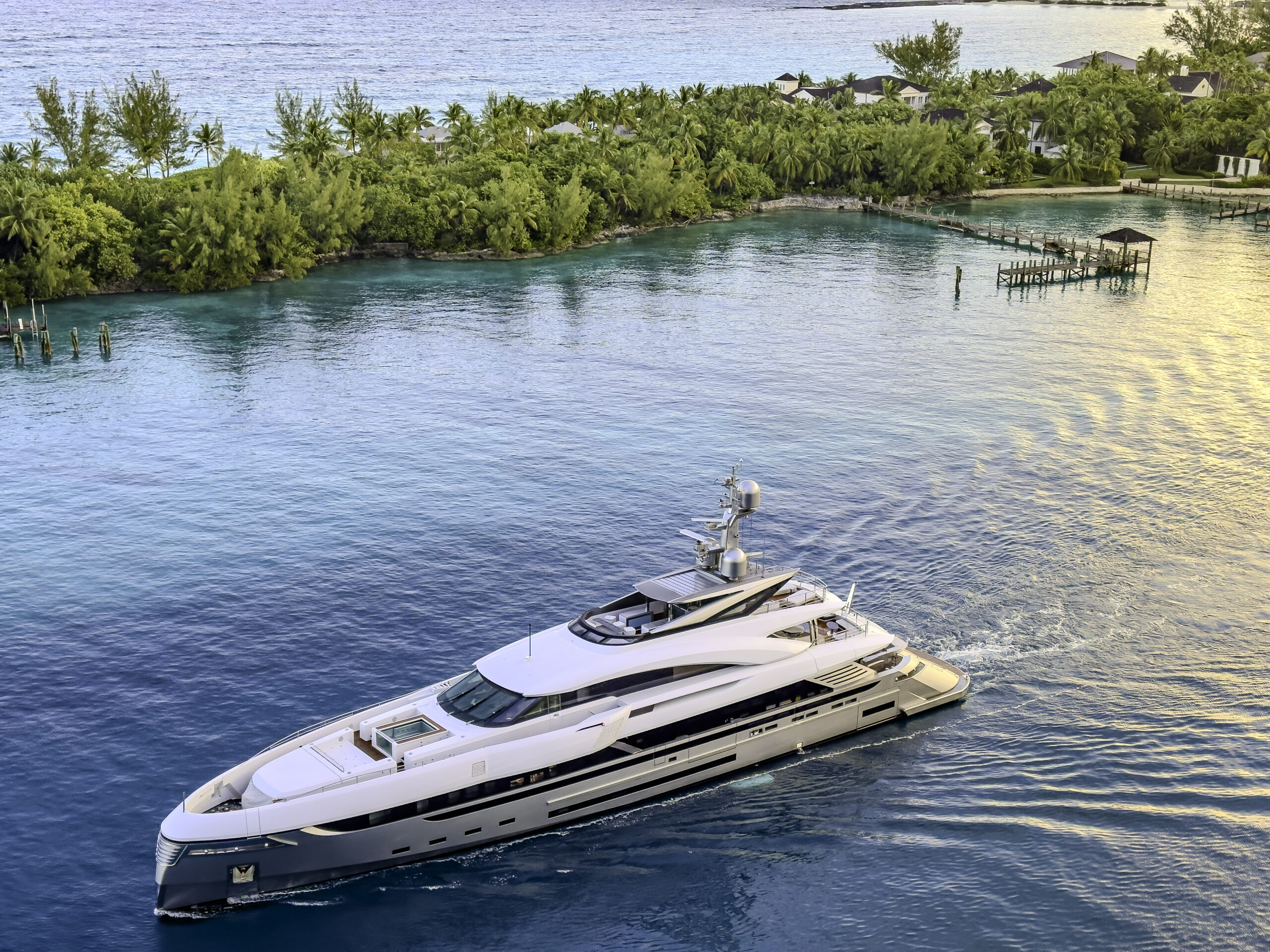 Elegant yacht sailing by lush coastline