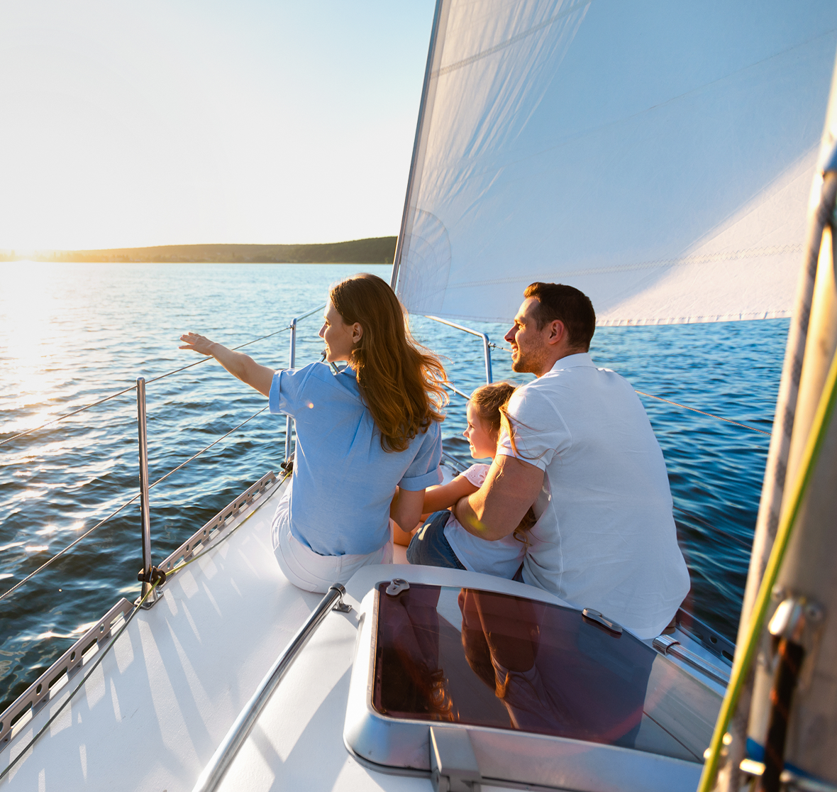 Family enjoying sunset on a sailboat