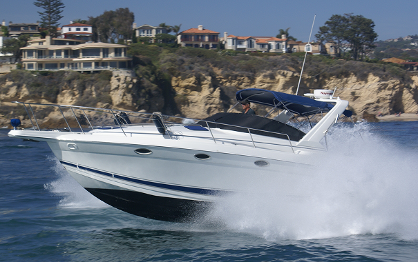 Boat cruising along rocky shoreline