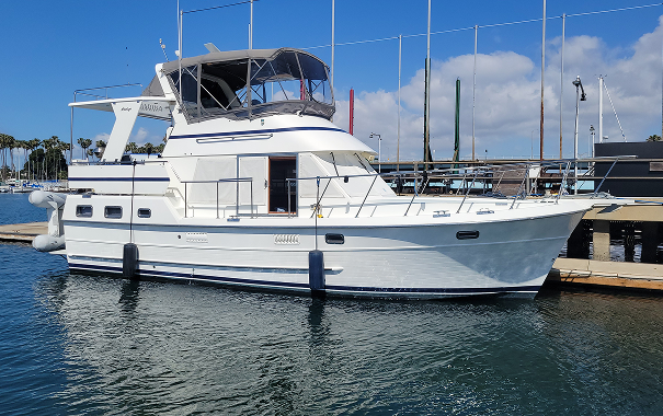 White yacht docked at marina