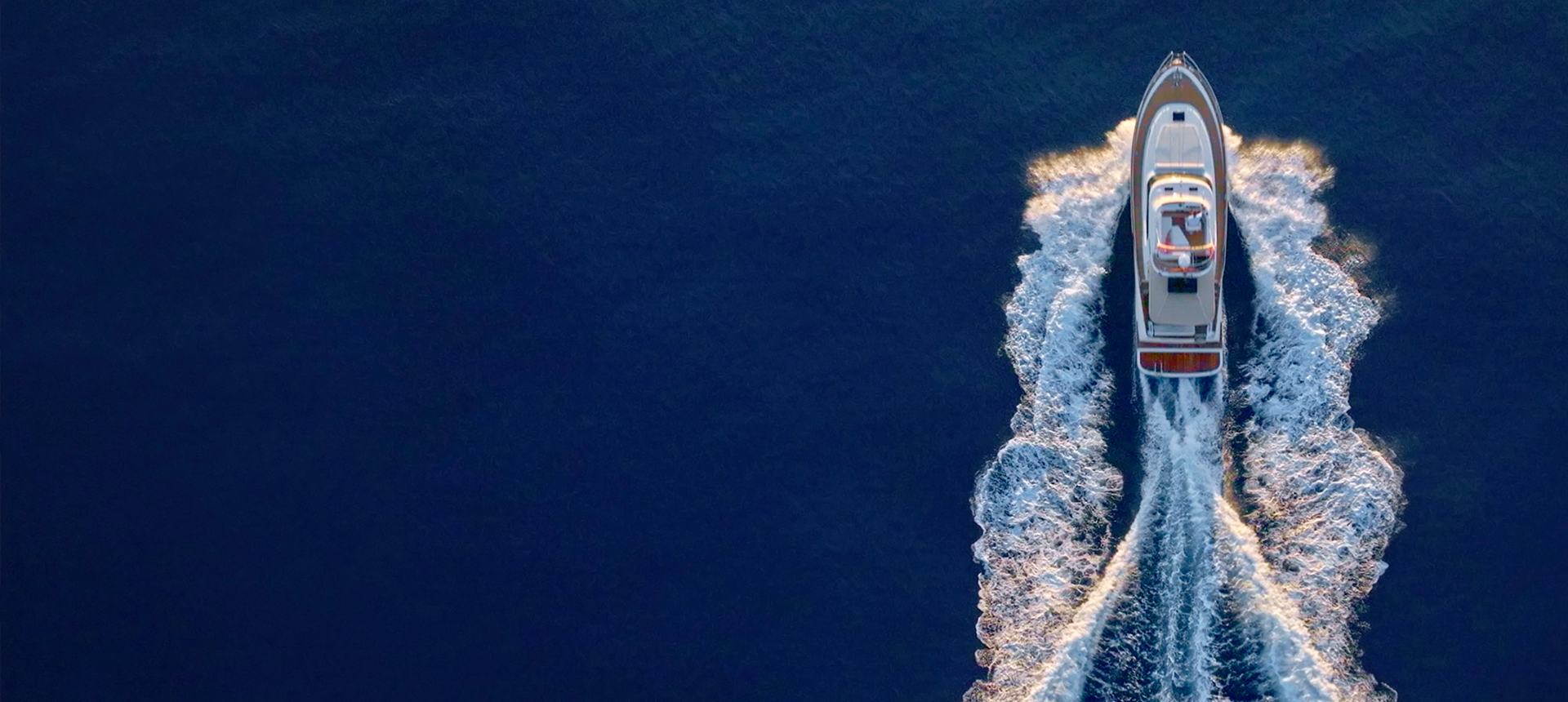 Aerial view of boat leaving wake